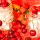 Ice filled sustainable glassware surrounded by sweet fresh organic red strawberries and cherries  - PhotoDune Item for Sale
