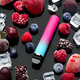 Electronic cigarette with berries and ice cubes on black background - PhotoDune Item for Sale