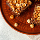 Brownie cake with nuts topping on plate close up - PhotoDune Item for Sale
