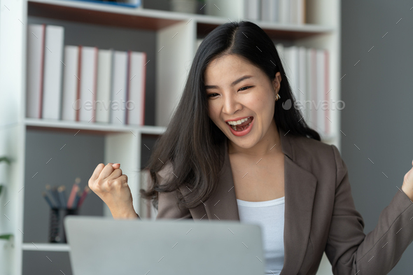 Asian businesswoman, investor showing a happy expression to know the results of financial approval R