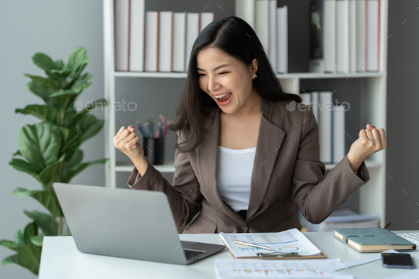 Asian businesswoman, investor showing a happy expression to know the results of financial approval R