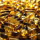 Many yellow Vitamin D, Fish Oil, Omega-3 capsules in sunshine light on table. Soft Fish Oil - PhotoDune Item for Sale
