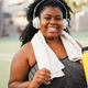 Plus size african woman smiling at camera after sport workout routine - PhotoDune Item for Sale