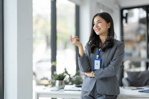 Confident young businesswoman, company employee smiling with arms crossed and happy in her performan
