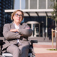businesswoman using wheelchair with arms crossed - PhotoDune Item for Sale
