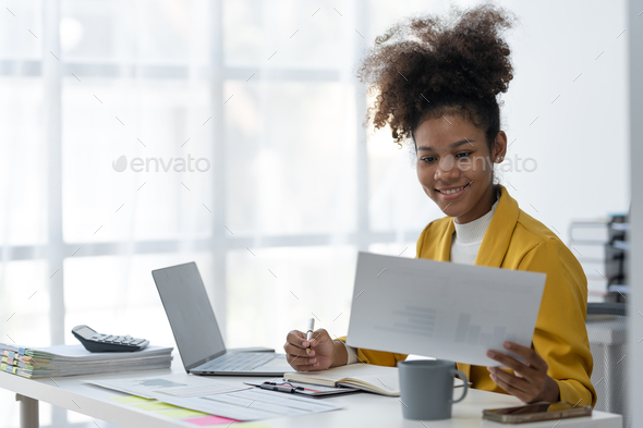 Confident African American Businesswoman Working On Documents Graphs