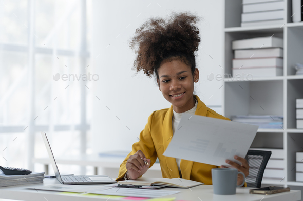 Confident African American Businesswoman Working On Documents Graphs