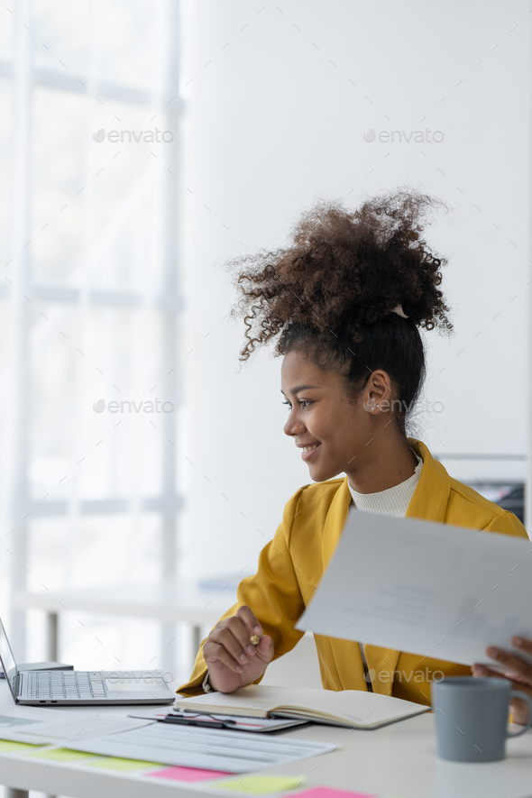 Confident African American Businesswoman Working On Documents Graphs