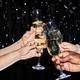 Hands toasting with champagne glasses at party with confetti - PhotoDune Item for Sale