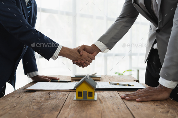 Handshake of real estate brokers with customers or investors, mortgage loan agreements Make a lease-