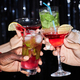 Close up of group of friends holding cocktails and toasting - PhotoDune Item for Sale