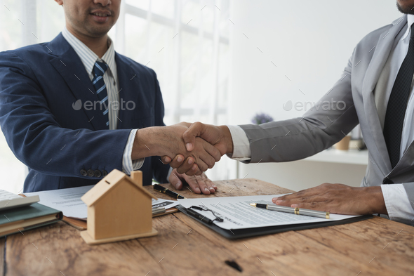 Handshake of real estate brokers with customers or investors, mortgage loan agreements Make a lease-