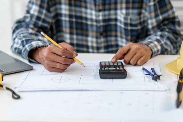 Architect engineer drawing plan blueprint of condominium or apartment ...