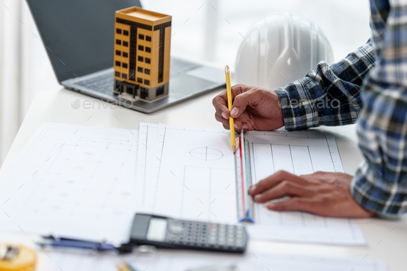 Architect engineer drawing plan blueprint of condominium or apartment ...