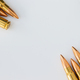 Bullets at corners of white circle on gray paper background. Cartridges 7.62 caliber - PhotoDune Item for Sale
