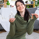 A happy woman in her house holds in her hands a miniature figure of a house and key in the interior. - PhotoDune Item for Sale