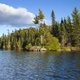 Lake in northern Minnesota with rocks and pines along the shore - PhotoDune Item for Sale