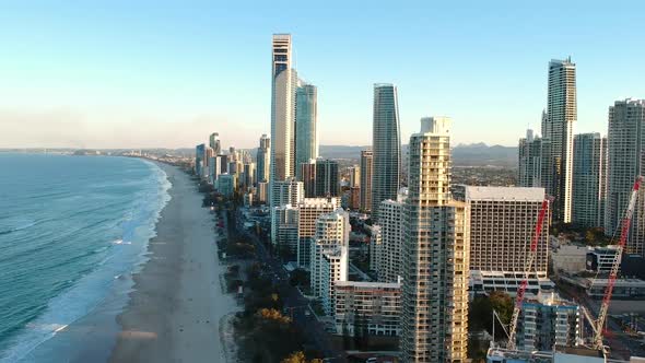 Aerial view of high-rise building built next to a popular tourist beach alt