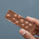  holding a nut dark chocolate  - PhotoDune Item for Sale