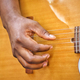Diverse black male gen x musician guitarist finger picks an acoustic guitar while performing live - PhotoDune Item for Sale