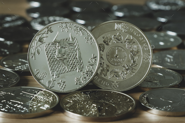 commemorative coin dedicated to the year of the bull on a background of different silver coins