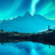Tourist on mountain lake during incredible Aurora borealis Northern lights - PhotoDune Item for Sale