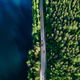Aerial view of road with cars between green forest and blue lake in Finland - PhotoDune Item for Sale
