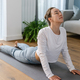 Young woman practicing yoga indoors at home. Healthy lifestyle. Home interior. - PhotoDune Item for Sale