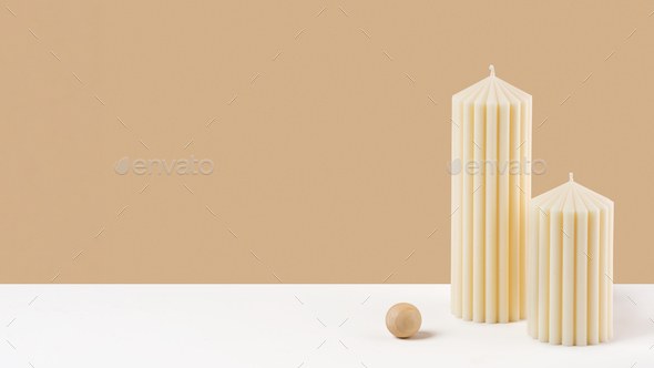 Handmade olive wax pillar candle on neutral pastel and white background.Sustainability vegan candle
