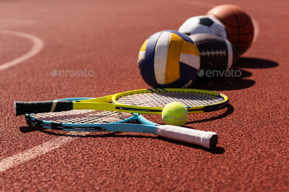 Set of sport equipment, rackets and tennis balls soccer and