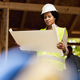 Black Woman Architect Checking Blueprints Project At Construction Site - PhotoDune Item for Sale