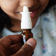 close up of sick child using nasal medicine spray - PhotoDune Item for Sale