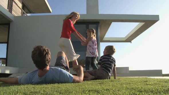 MS OF A FAMILY PLAYING IN A GARDEN alt