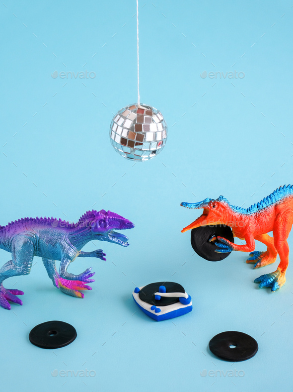 Cute dinosaurs toy listen vinyl on vinyl record player with his friend on blue background.