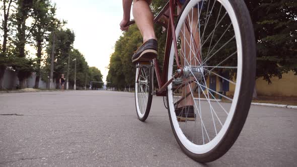 Young Man Riding a Vintage Bicycle at the Park Road. Sporty Guy Cycling Outdoor. Healthy Active alt