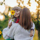 Portrait of beautiful family - 4 years old boy with sunflower, mother in garden - PhotoDune Item for Sale