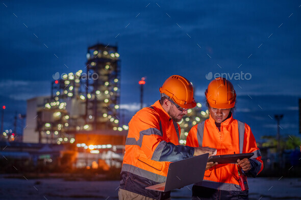 Engineer wear uniform and helmet stand workplace hand holding tablet and laptop computer, survey ins