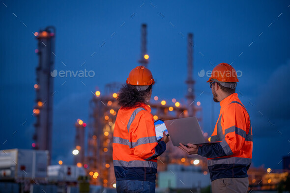 Engineer wear uniform and helmet stand workplace hand holding tablet and laptop computer, survey ins