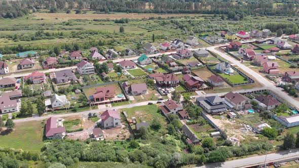 Drone flight over a residential area of private houses.  Aerial view of houses, roofs