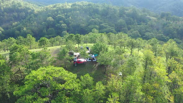 Aerial view of group Asian friends camp enjoying, relaxing nature on the hills