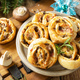 Pizza rolls puff pastry stuffed with prosciutto bacon, mushrooms and cheese on the Christmas table. - PhotoDune Item for Sale