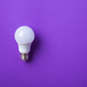 White lightbulb on purple background. - PhotoDune Item for Sale