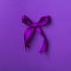 Purple bow ribbon isolated on purple background. - PhotoDune Item for Sale