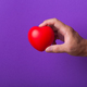 Hand with red heart on purple background. - PhotoDune Item for Sale
