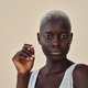 Cool gen z African girl with short blond hair at beige background. Portrait. - PhotoDune Item for Sale