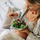 A beautiful pregnant woman, taking care of her health, has breakfast with a green salad. - PhotoDune Item for Sale