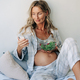 A pregnant woman eats salad and chats online on the Internet. - PhotoDune Item for Sale