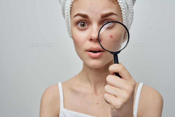 Closeup Of Womans Hand Holding Magnifying Lens High-Res Stock