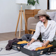 Woman packs things in preparation for a holiday, preparing things for a weekend trip. - PhotoDune Item for Sale