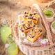 Blueberries yeast cake on beach on wicker basket in summer. - PhotoDune Item for Sale